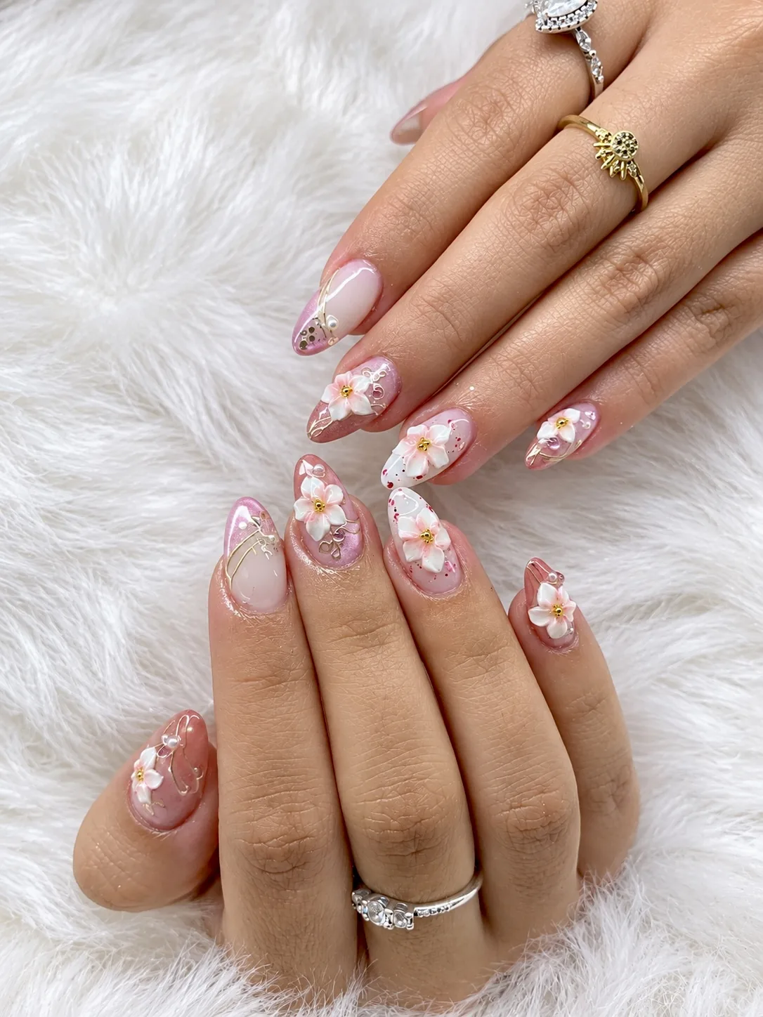Pink almond nails with 3D white flowers and gold line art by Jhane at AyuriNails Beauty Lounge